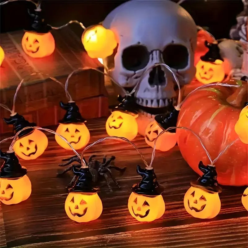 Calabazas de la Pumpkin Glow encendidas junto a una calavera de adorno