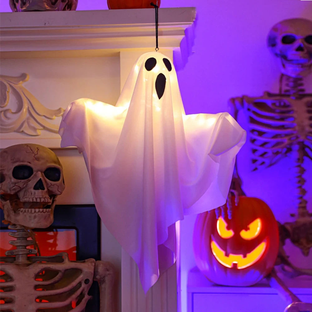 Ghost Glow colgado de una repisa de chimenea, junto a una calabaza encendida
