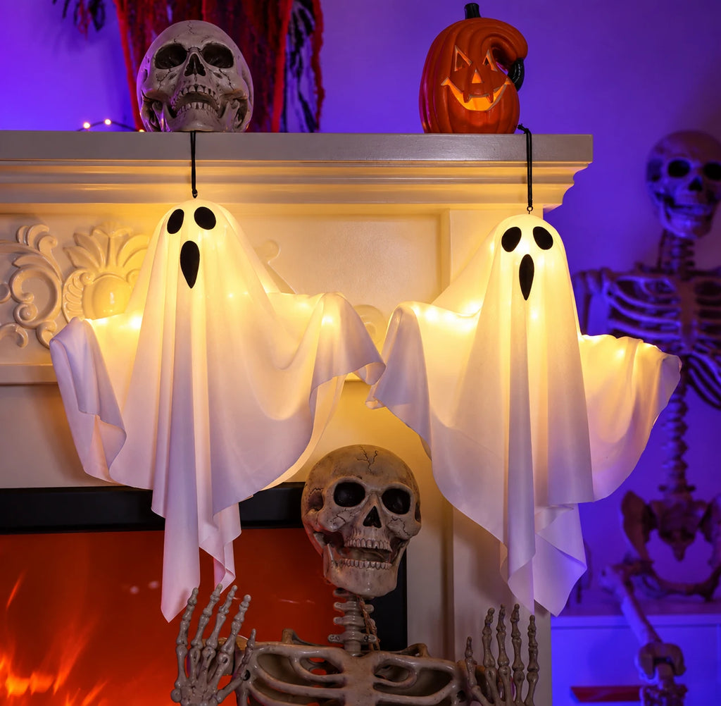 Dos Ghost Lights colgados de la repisa de una chimenea decorada de Halloween